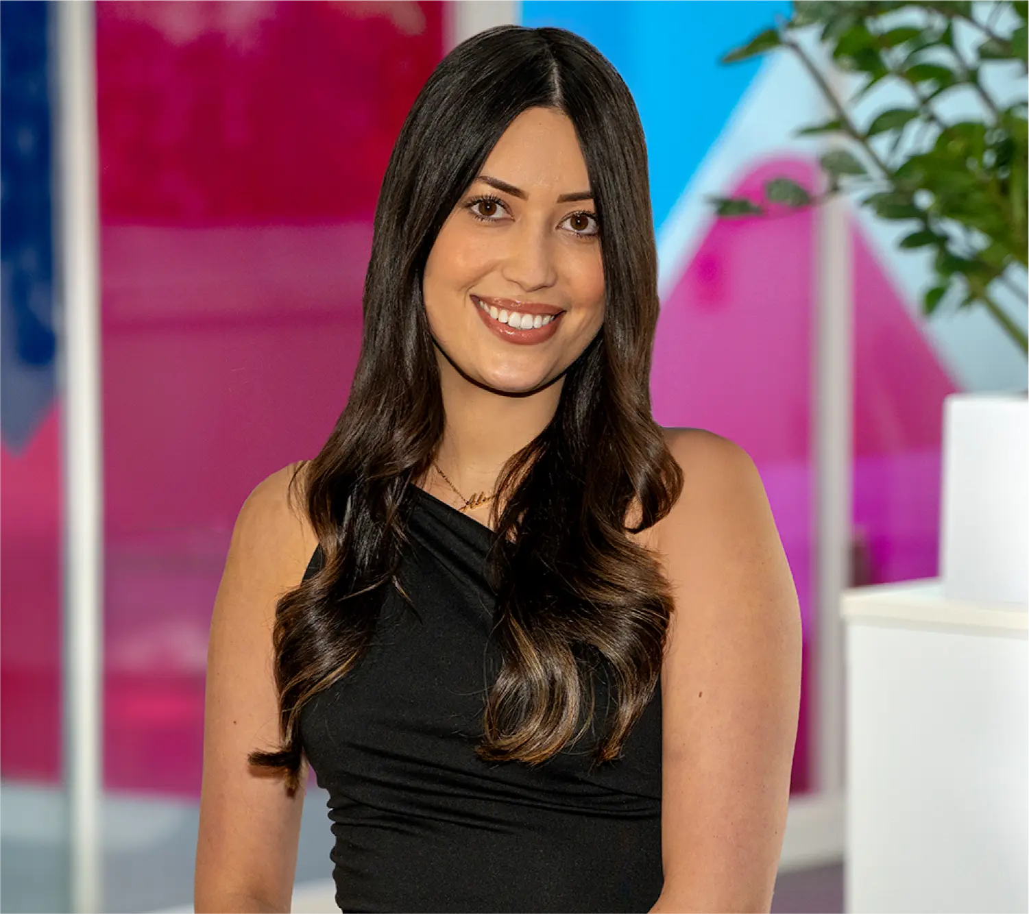 Photo of Alice Hoy, Commercial Customer Service Team Leader at Utilita Business, sat in front of colourful glass panels.