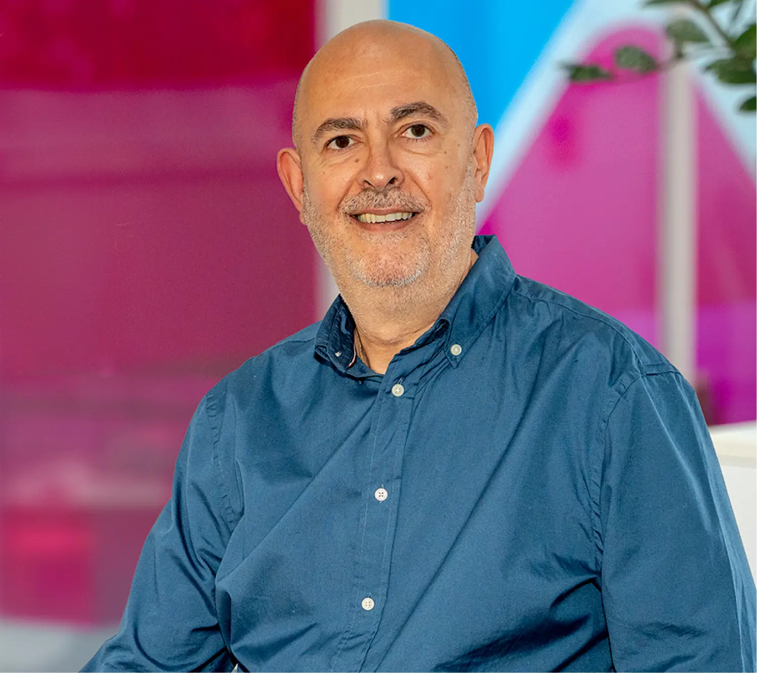 Photo of Steven Underwood, Commercial Sales Team Leader at Utilita Business, sat in front of colourful glass panels.
